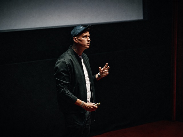 Speaking on stage at an industry event